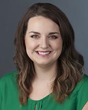 Holly Scheirman in green shirt smiling